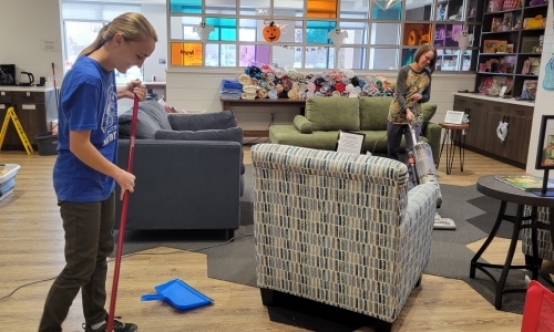 Girl and Mom Cleaning the Family Room