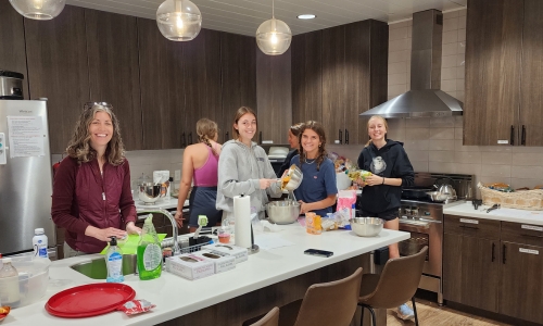 Group Cooking a Meal in the Family Room