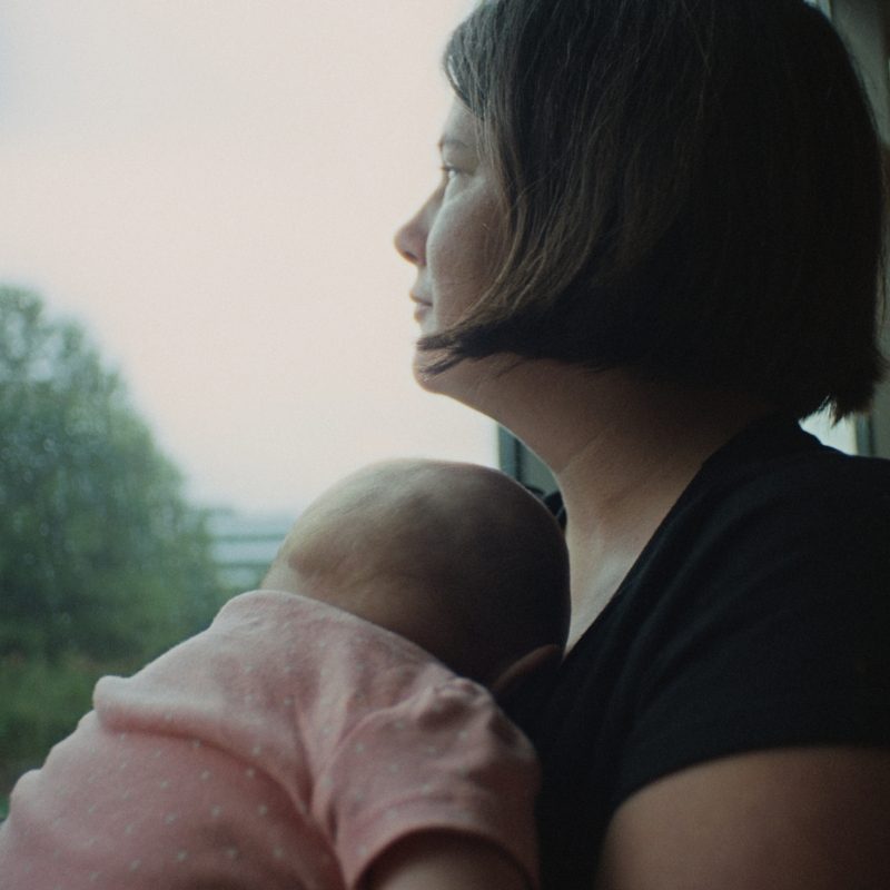 Mom Holding Baby Looking out the Window